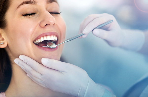 Woman getting dental exam in Salem, OR office.