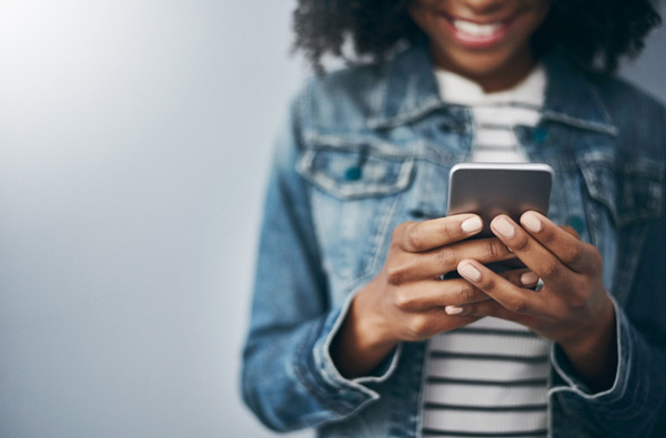 Woman looking at website on her phone in Salem, OR office.